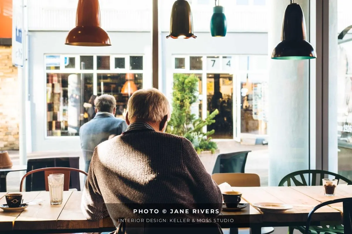 A café interior with a two-line credit on a soft band: photo by Jane Rivers and interior design by the studio