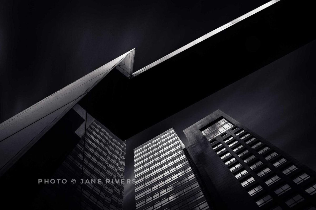 The same building photo with a soft gray credit