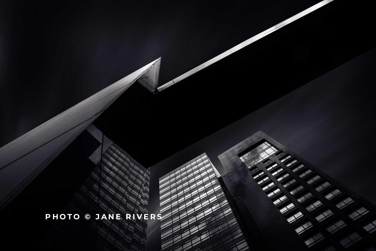 A dark graphic building photo with a bright white credit