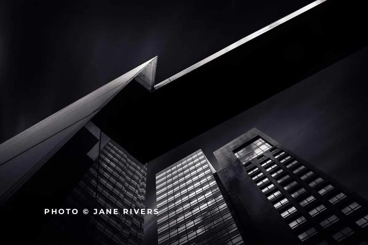 A dark graphic building photo with a bright white credit