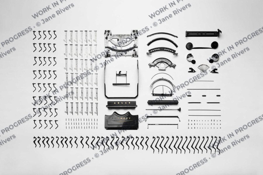Sketches and design studies laid out on paper with a tiled WORK IN PROGRESS watermark
