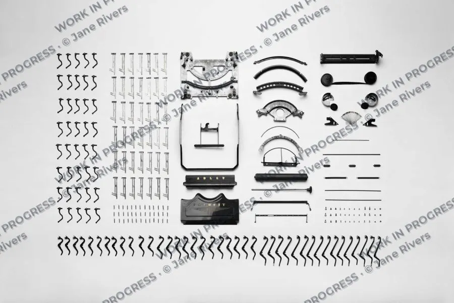 Sketches and design studies laid out on paper with a tiled WORK IN PROGRESS watermark