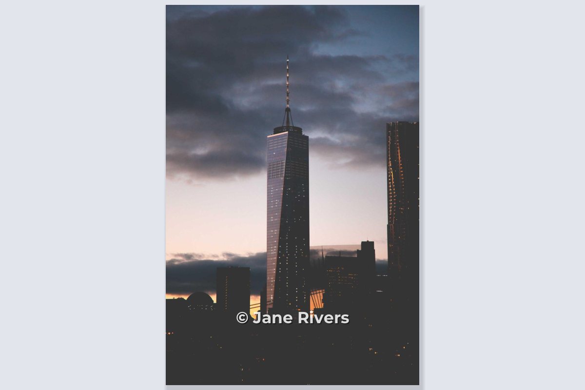 A portrait photo of a tower at dusk with the mark centered near the bottom