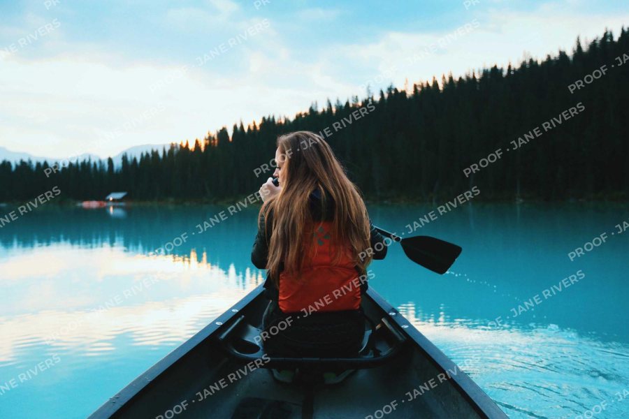 The canoe photo with a small PROOF and studio name repeated in a rotated tiled pattern