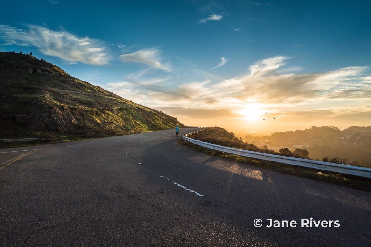 A mountain road at sunset with a small copyright watermark in the lower right corner