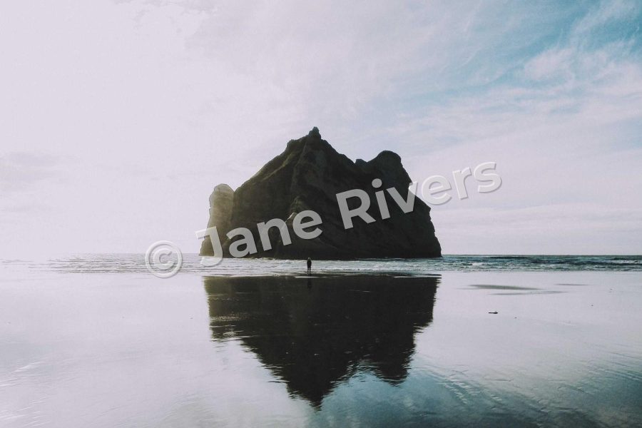 A rock reflected in still water with a watermark tilted at 15 degrees