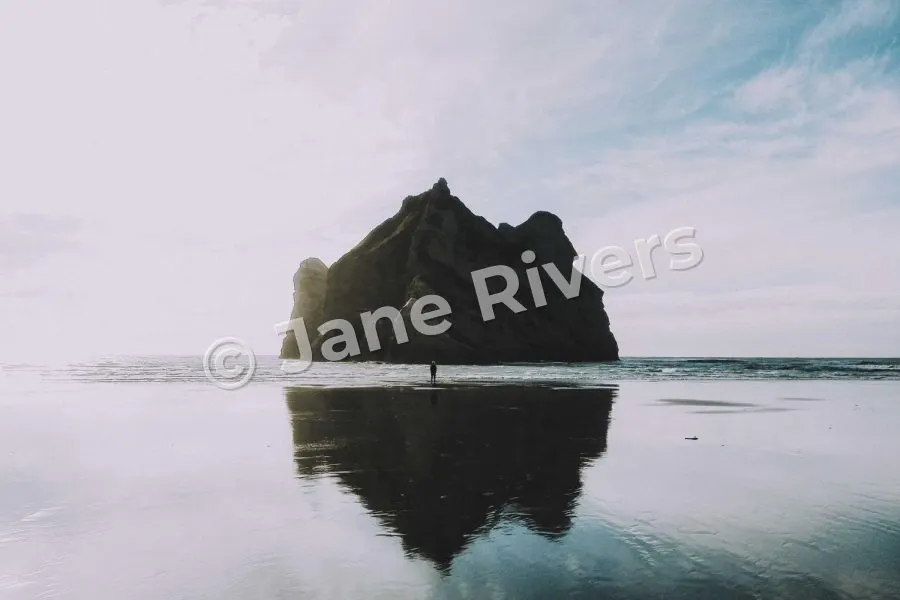 A rock reflected in still water with a watermark tilted at 15 degrees