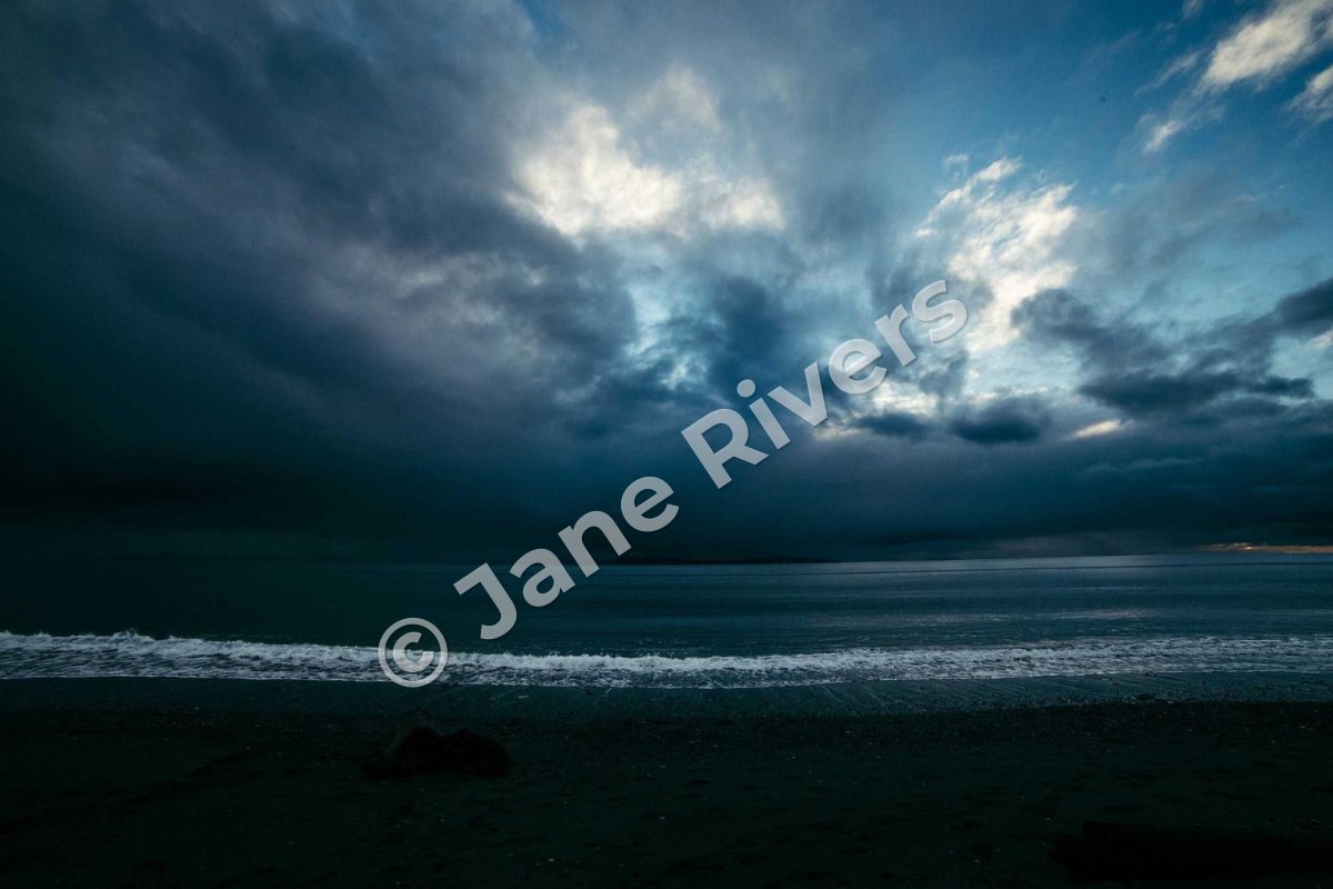 The same stormy sea with the same watermark tilted so it crosses the sky, the sea and the shore