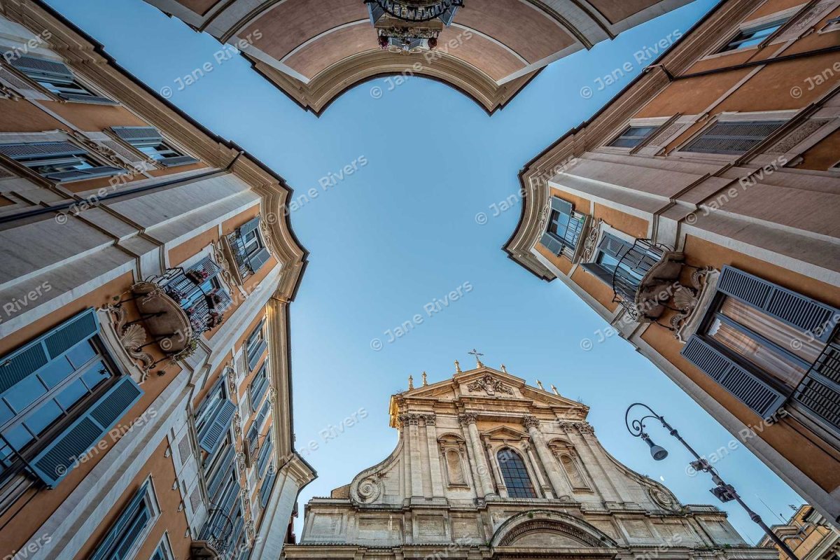 The same buildings with many small angled copies of the watermark repeated across the whole photo