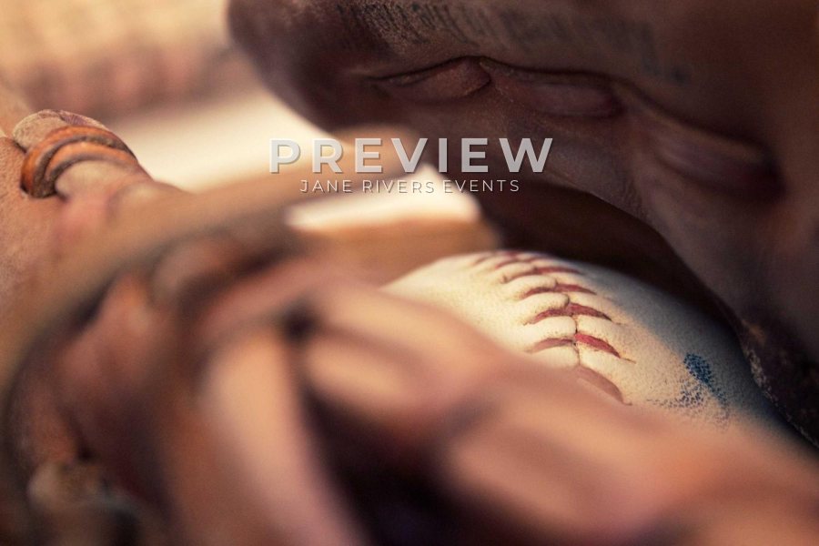 A close-up of a baseball in a glove with a PREVIEW mark in the upper area