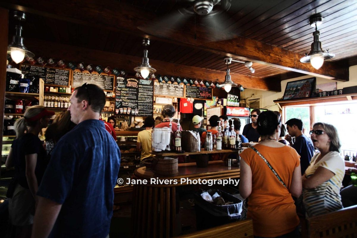 A busy café bar with customers and a © Jane Rivers Photography watermark in the lower middle of the frame