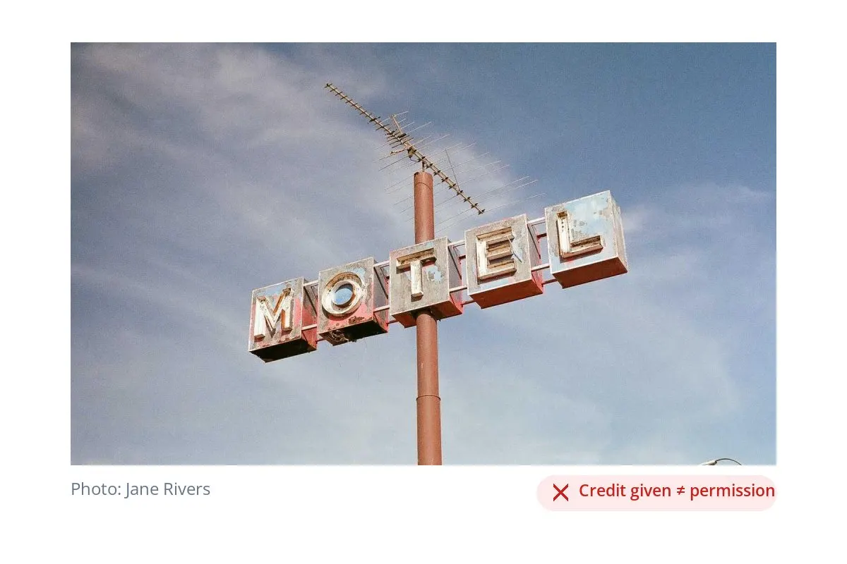 A photo of a vintage motel sign with a photo credit underneath and a red label reading Credit given does not equal permission