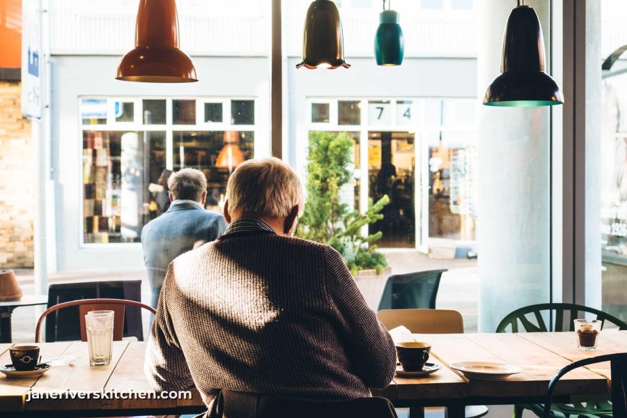 A café interior with a small white website watermark in the lower left