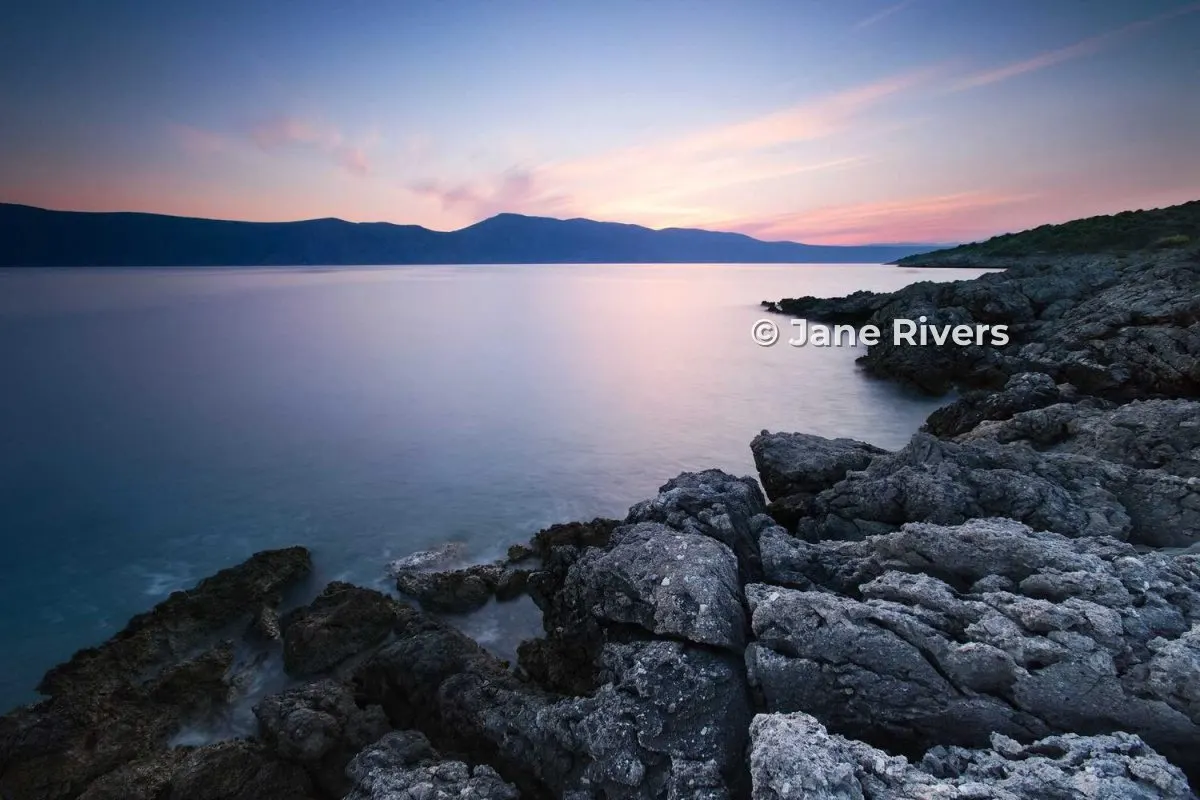 The same coastline photo with a small © Jane Rivers credit, for sharing online