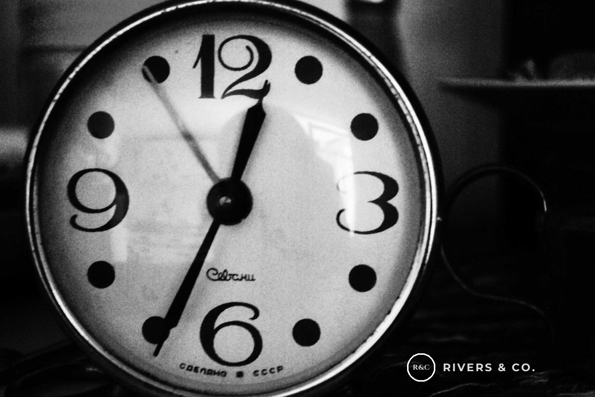 The same clock with a small logo in the dark bottom-right corner