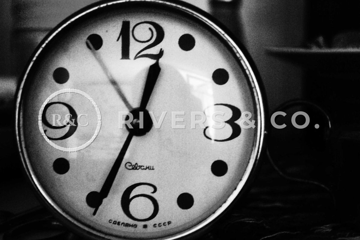 A clock face with a large logo across the numbers, making the product hard to see