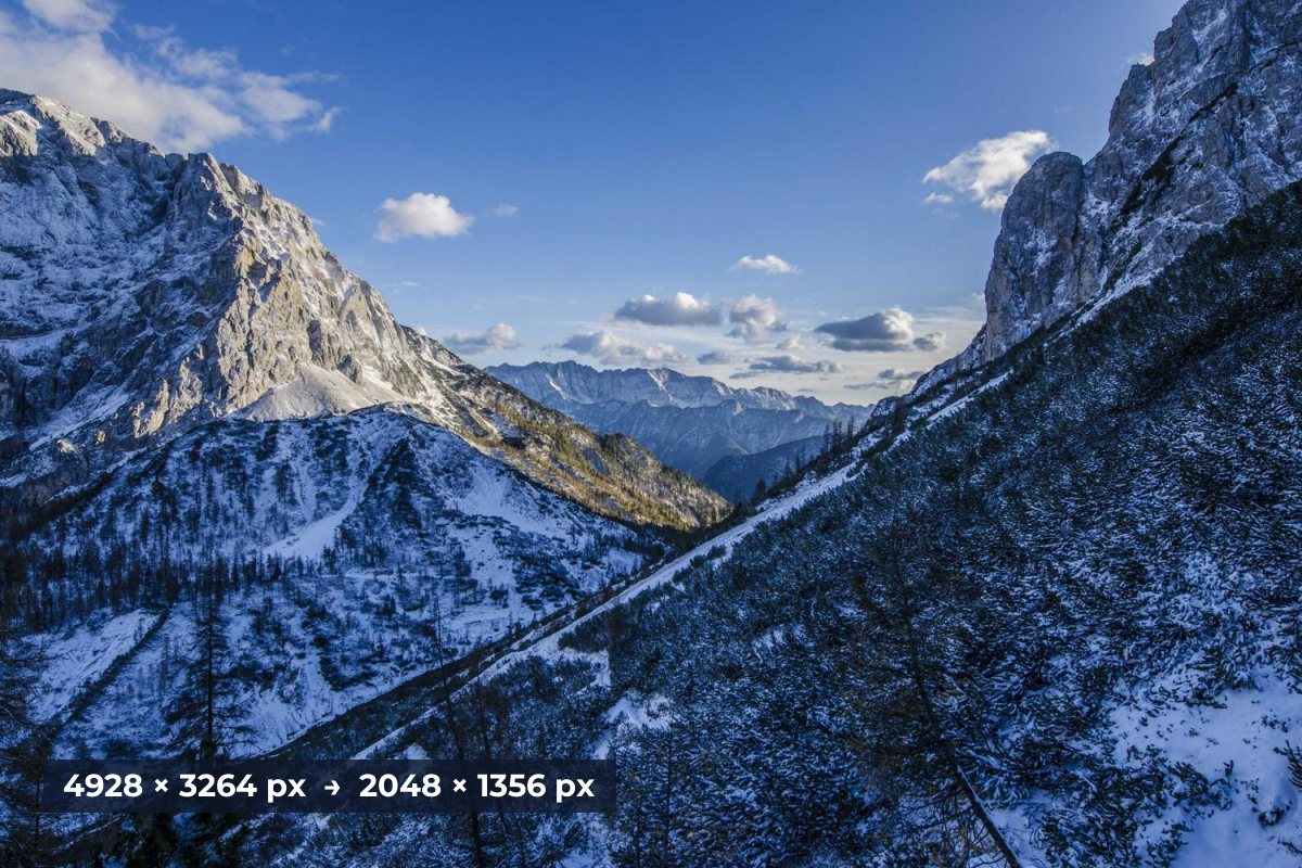 A snowy mountain valley with a label showing the original size of 4928 by 3264 pixels reduced to 2048 by 1356 pixels