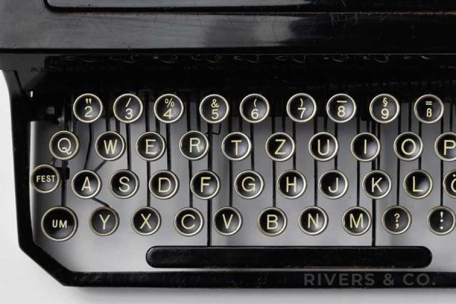A close-up of typewriter keys with a small shop mark in the corner