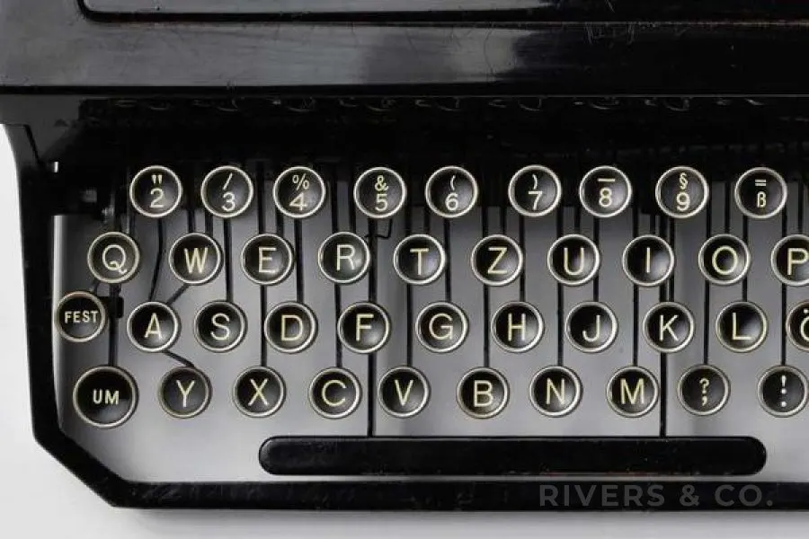 A close-up of typewriter keys with a small shop mark in the corner