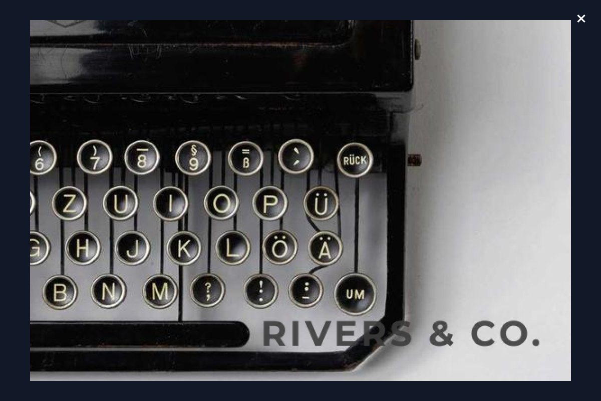 The same typewriter photo opened in a full-screen lightbox, showing the keys in close detail with the shop mark still in the corner