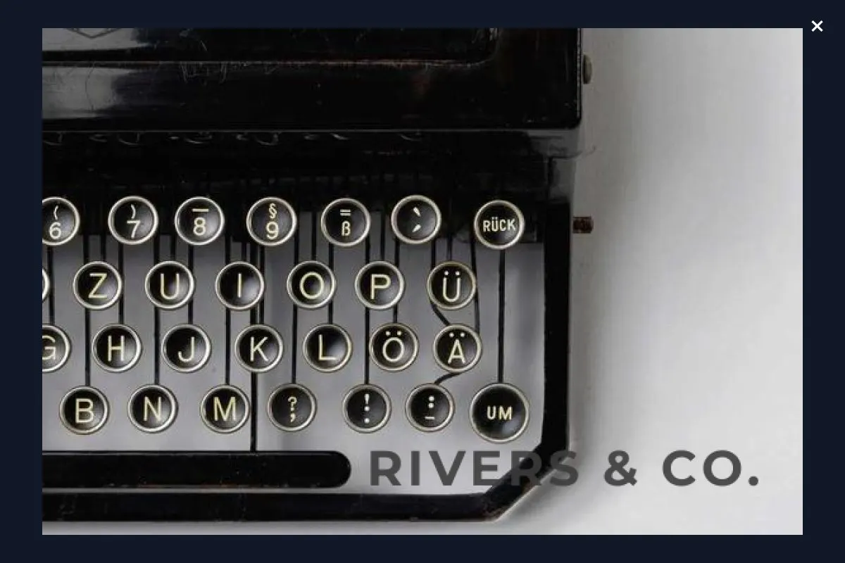 The same typewriter photo opened in a full-screen lightbox, showing the keys in close detail with the shop mark still in the corner