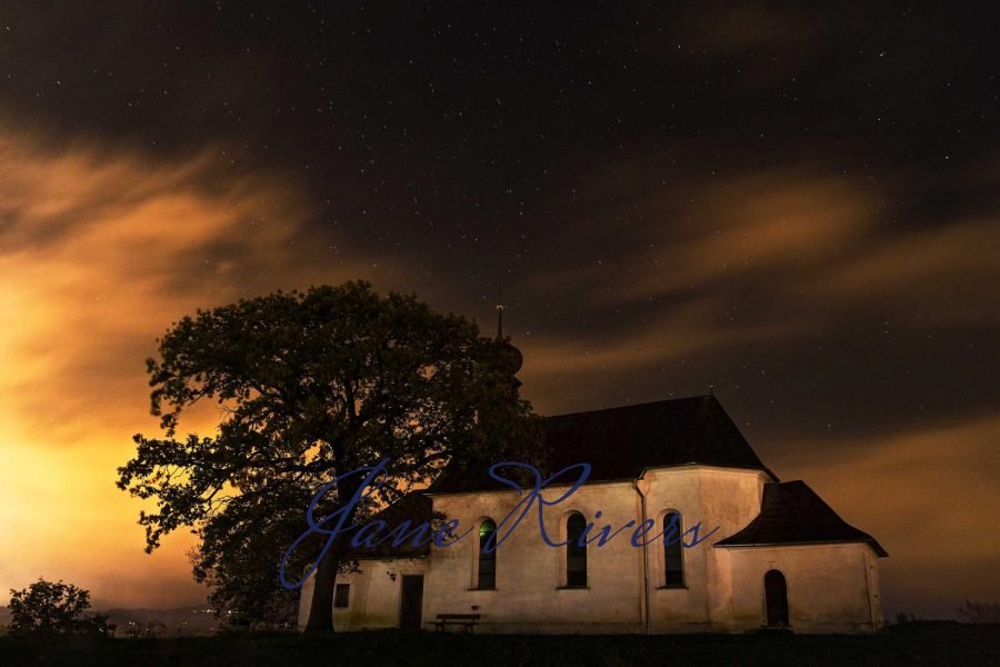 A dark blue ink signature with no background, almost invisible against the dark night sky