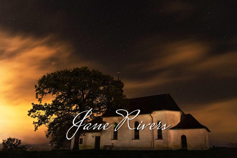 The same signature in white with a soft shadow, clearly visible against the night scene