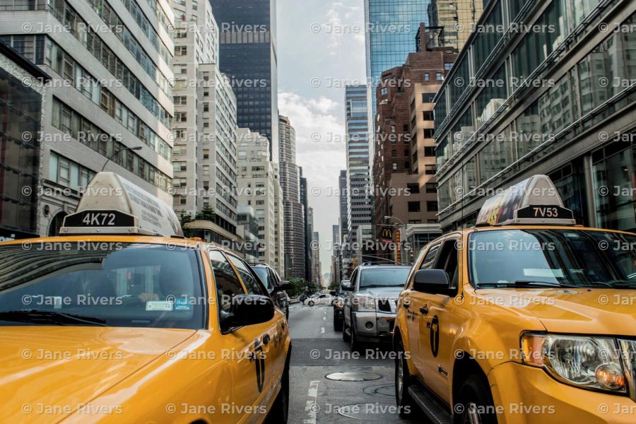 A New York street with taxis and a level, horizontal tiled watermark lining up with the building windows