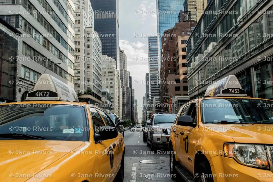 A New York street with taxis and a level, horizontal tiled watermark lining up with the building windows