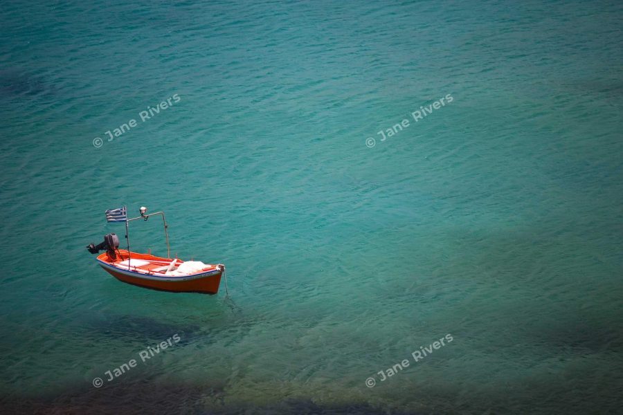 A boat on teal water with a few widely spaced watermarks and large empty areas