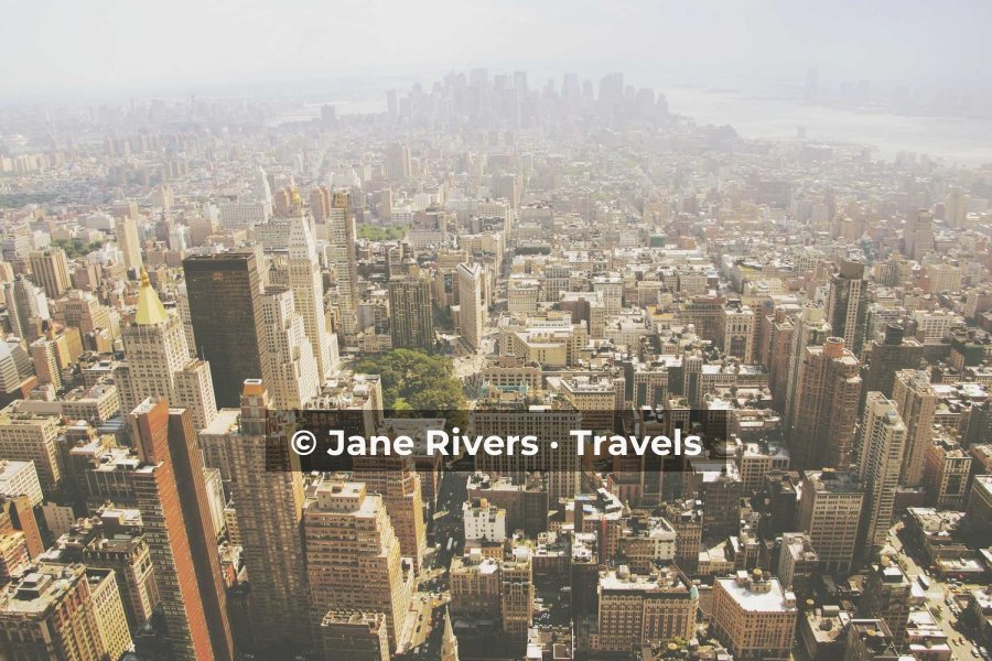 A dense hazy cityscape with the watermark on a soft dark band