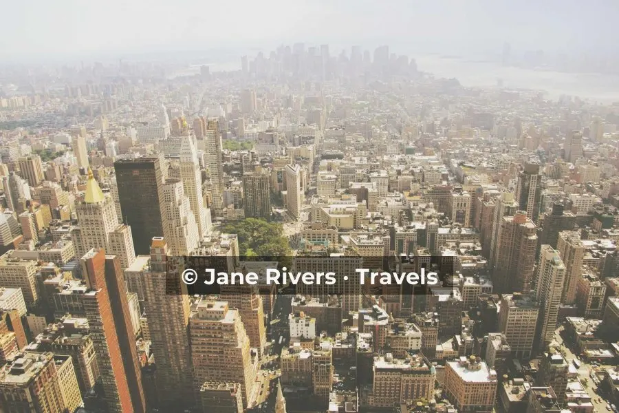A dense hazy cityscape with the watermark on a soft dark band