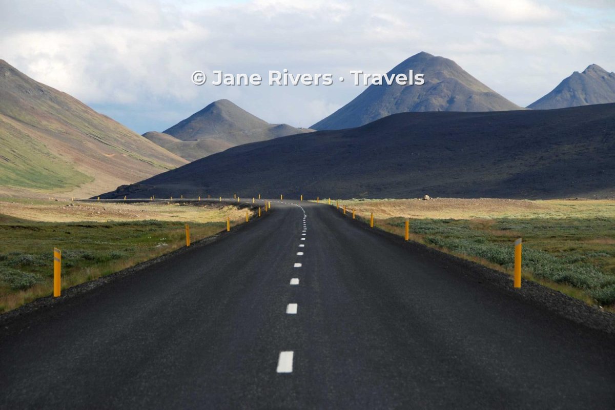 A mountain road with the watermark placed in the empty sky