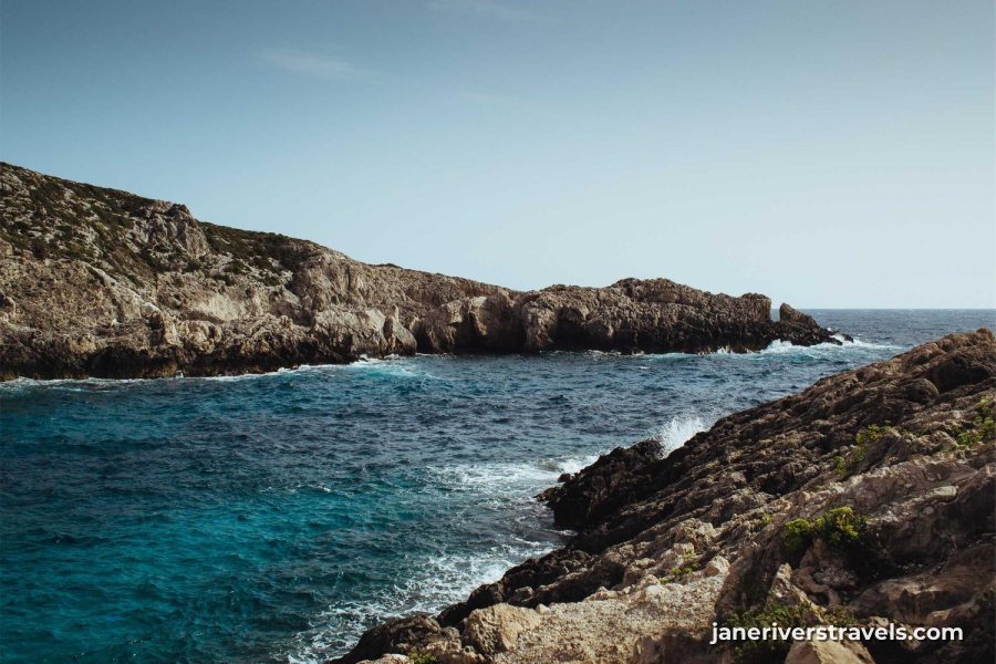A rocky coastline with a small website address in the lower right