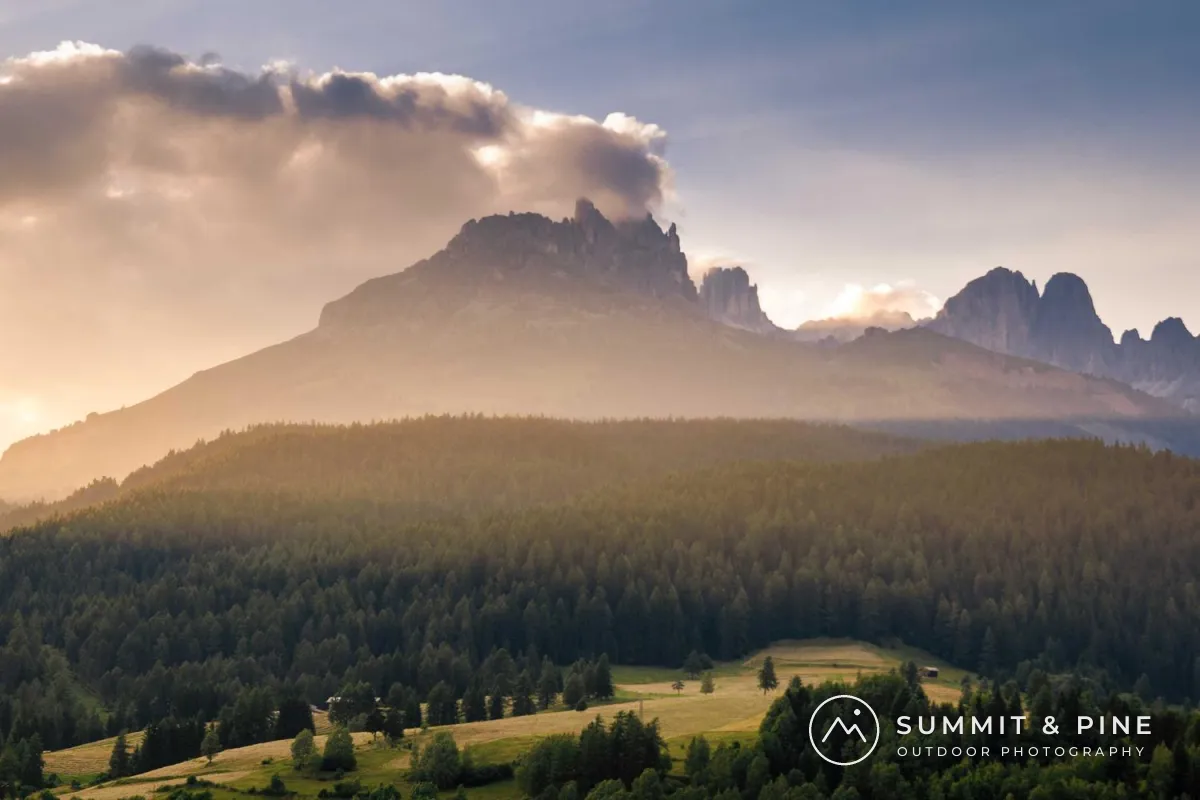 Mountains above a pine forest at sunset with a white logo in the lower right: a circle with a mountain line, next to SUMMIT & PINE and OUTDOOR PHOTOGRAPHY in smaller letters