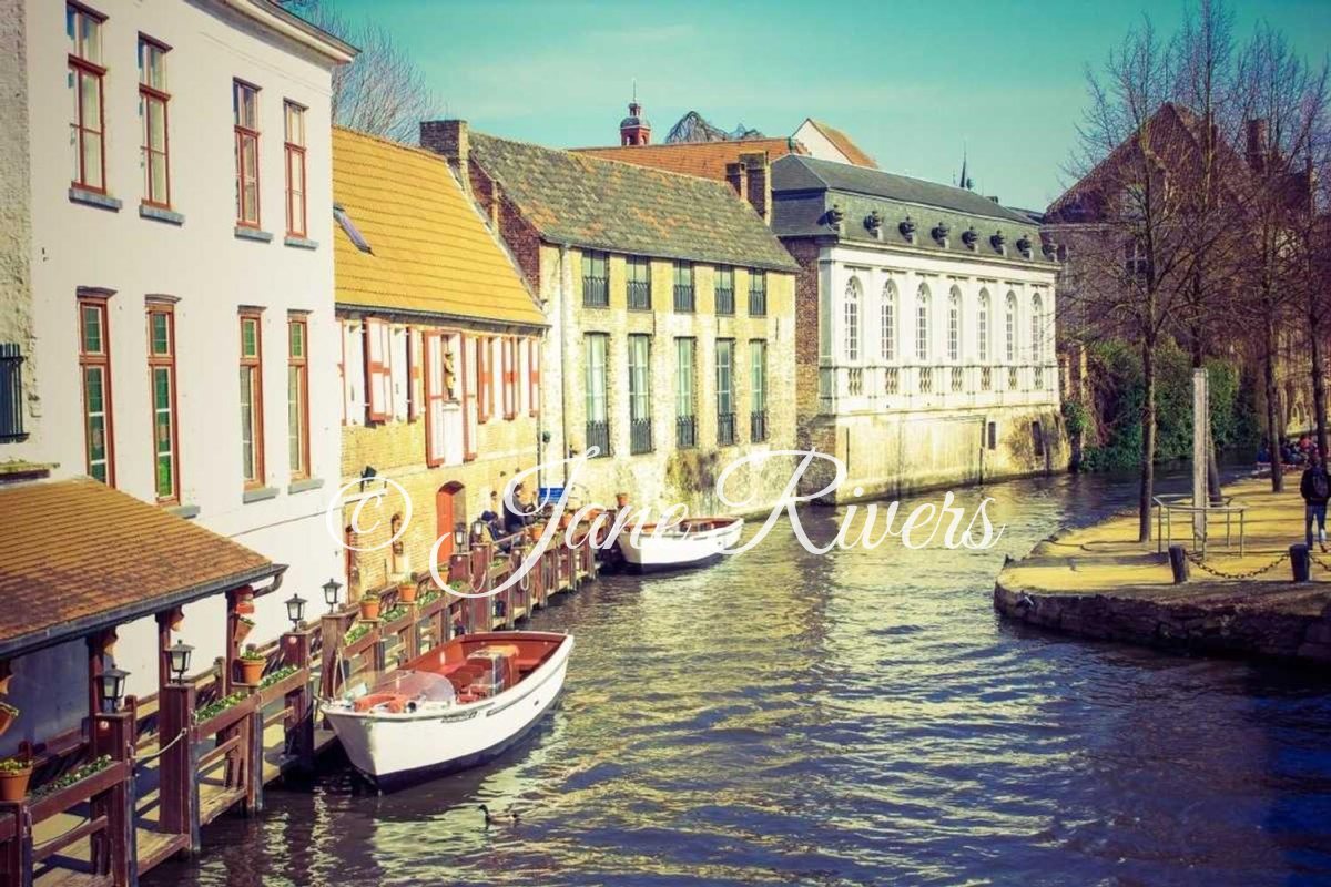 A busy canal street scene with a script watermark that blends into the buildings and water
