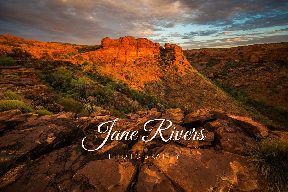 A red canyon at sunset with a script watermark reading Jane Rivers and the word Photography in spaced capitals below it