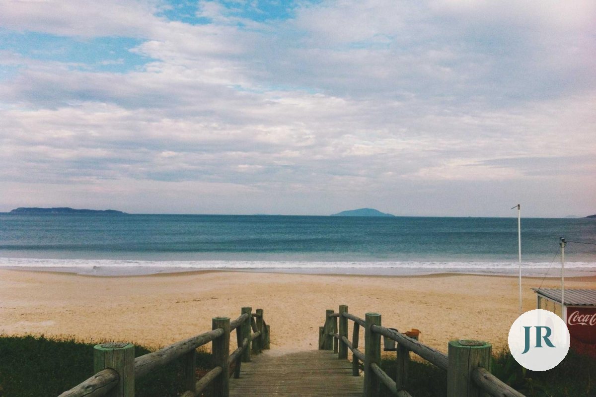 The same beach with a clean, semi-transparent round logo and no box