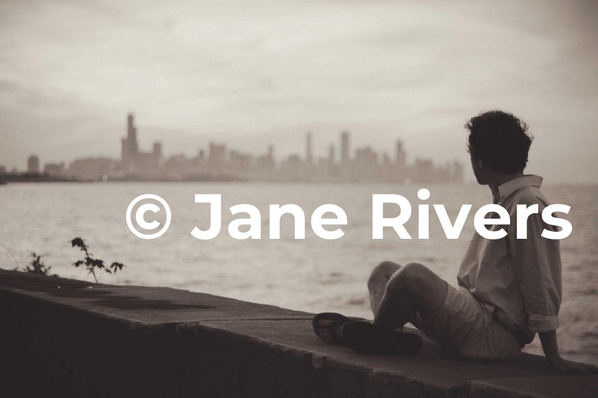 A person sitting by the water looking at a city skyline, with a huge solid white watermark across them