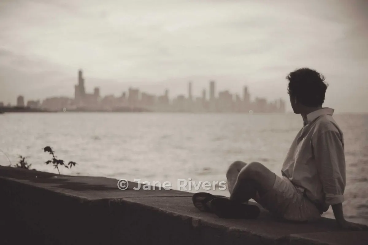 The same photo with a moderate, semi-transparent watermark on the wall beside the person