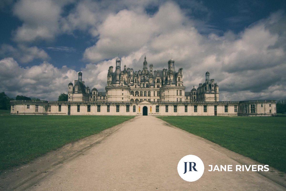 A chateau photo with a solid white circular logo and name in the corner at full opacity