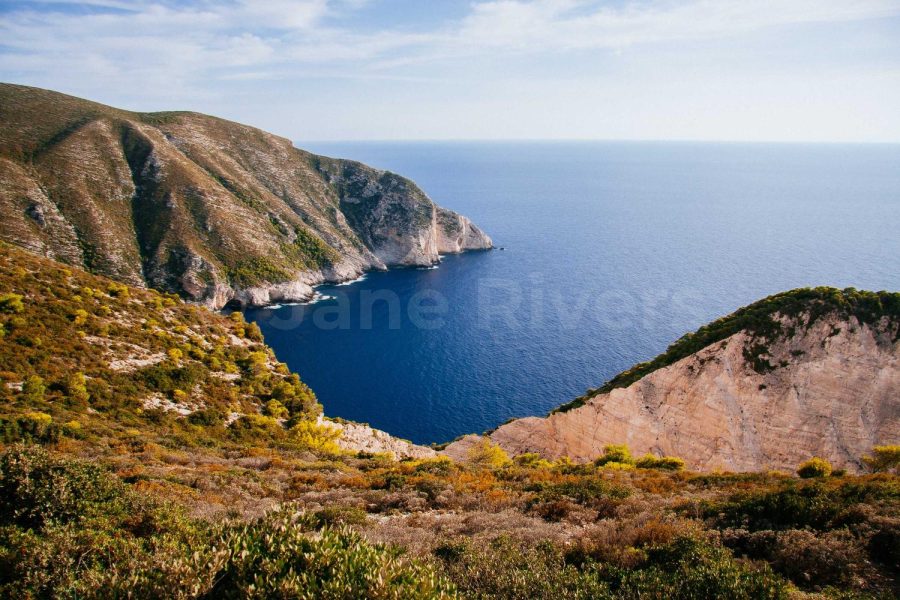 A coastal cliff photo with a Jane Rivers watermark at 10% opacity that is almost invisible