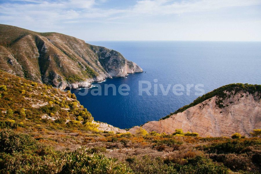 The same coastal photo with the watermark at 25% opacity