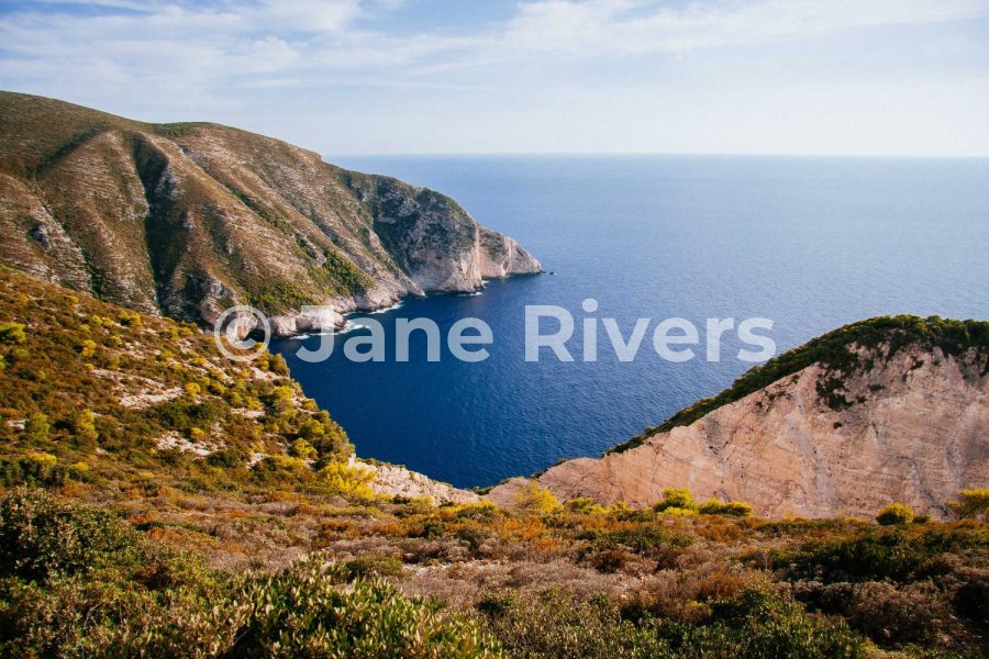 The same coastal photo with the watermark at 50% opacity