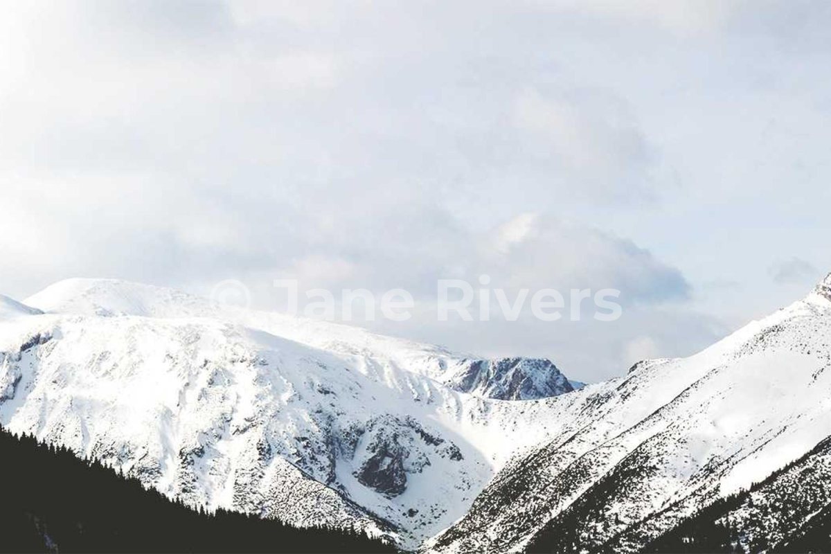 A bright snowy mountain photo with the same white watermark at 35% opacity that is almost invisible