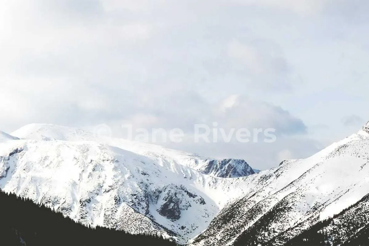 A bright snowy mountain photo with the same white watermark at 35% opacity that is almost invisible