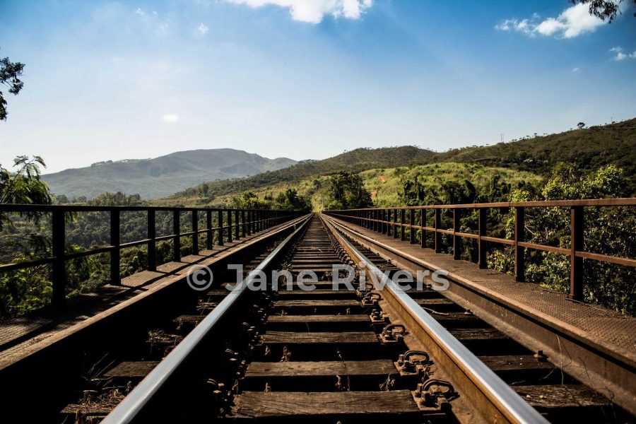 The same railway photo with a medium watermark over the tracks at 45% opacity