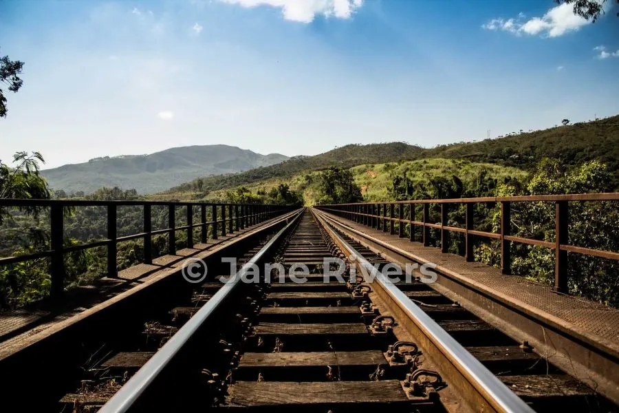 The same railway photo with a medium watermark over the tracks at 45% opacity