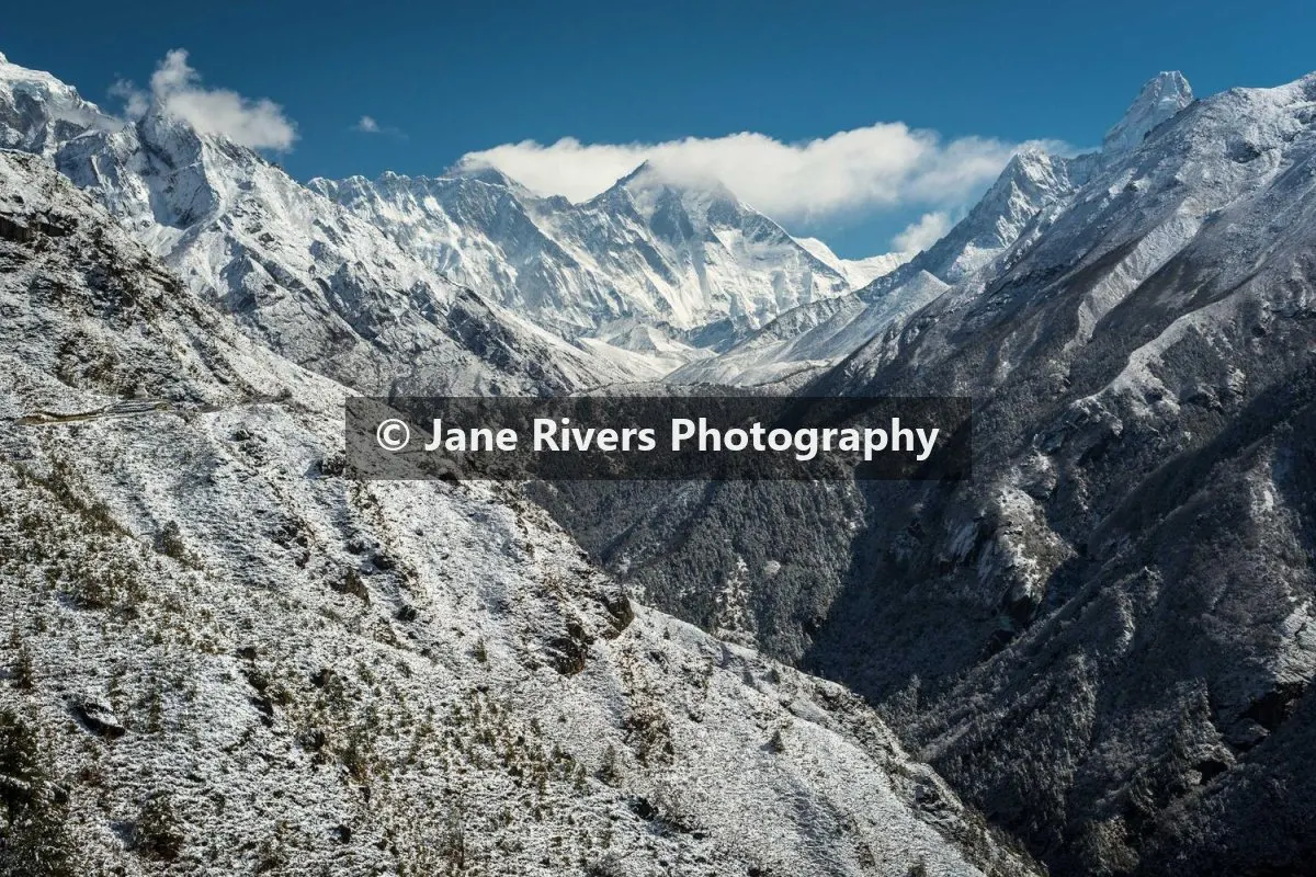 The same mountain photo with the watermark on a semi-transparent dark backing