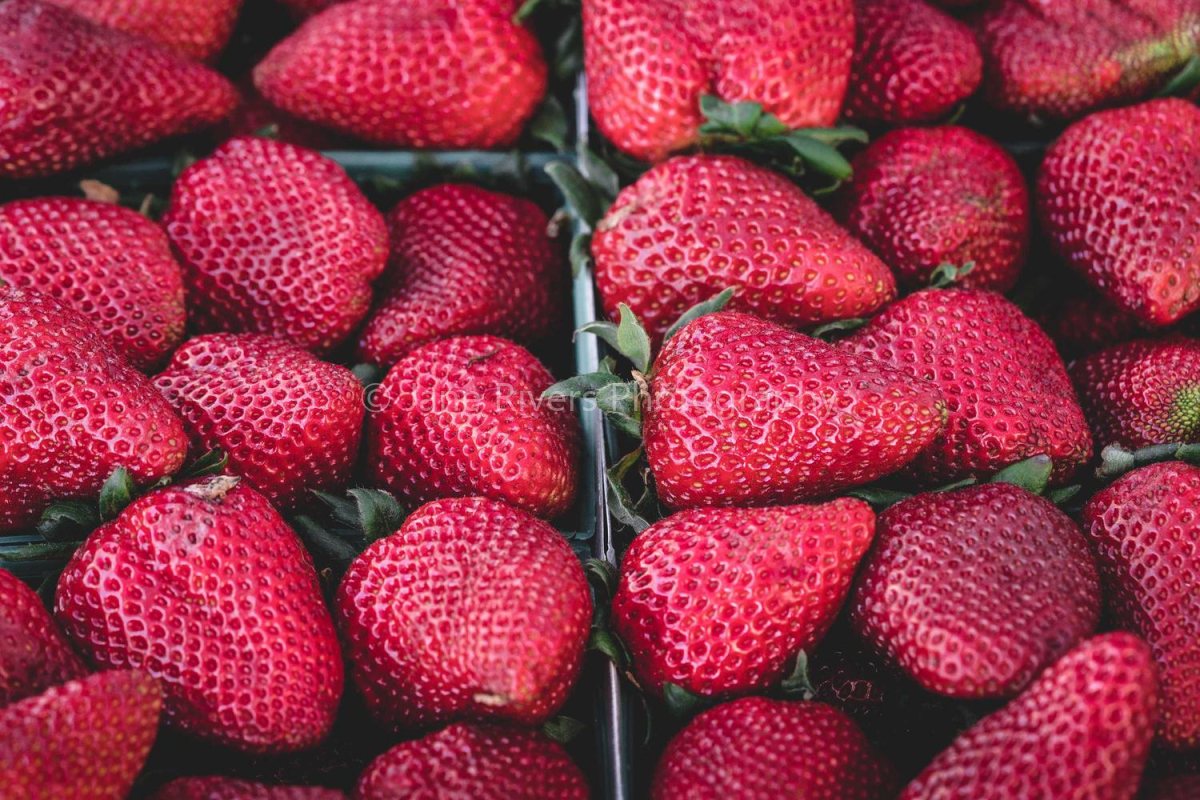 A photo of strawberries with a faint watermark that is almost invisible